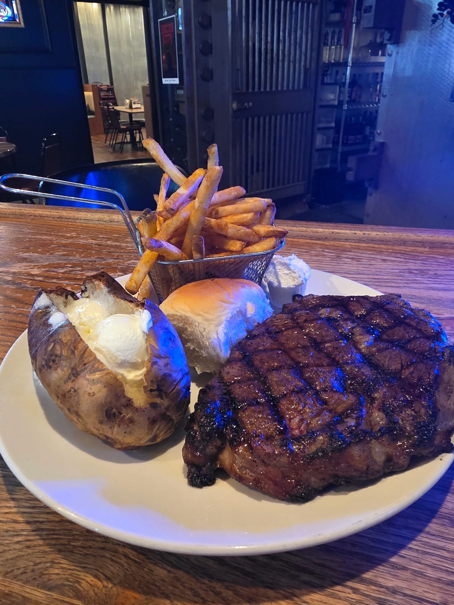 Ribeye steak with loaded baked potato