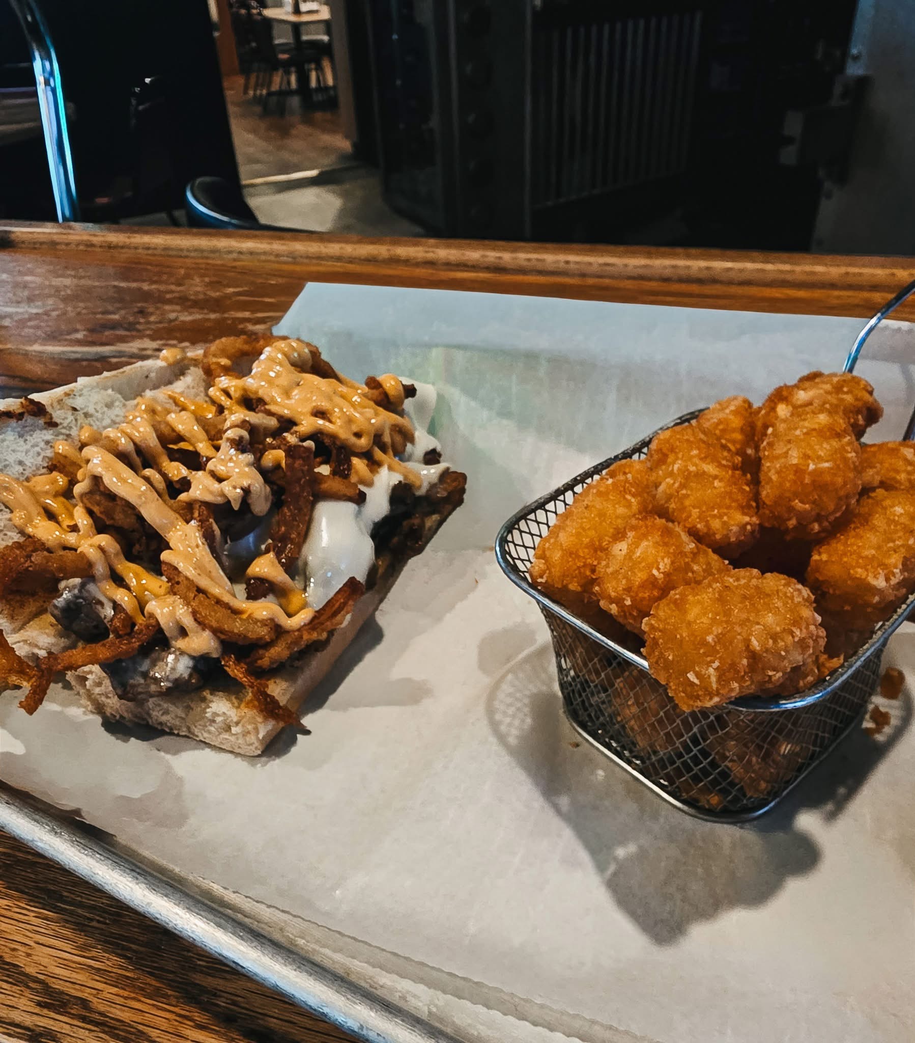 The Vault Philly open-faced sandwich with tots