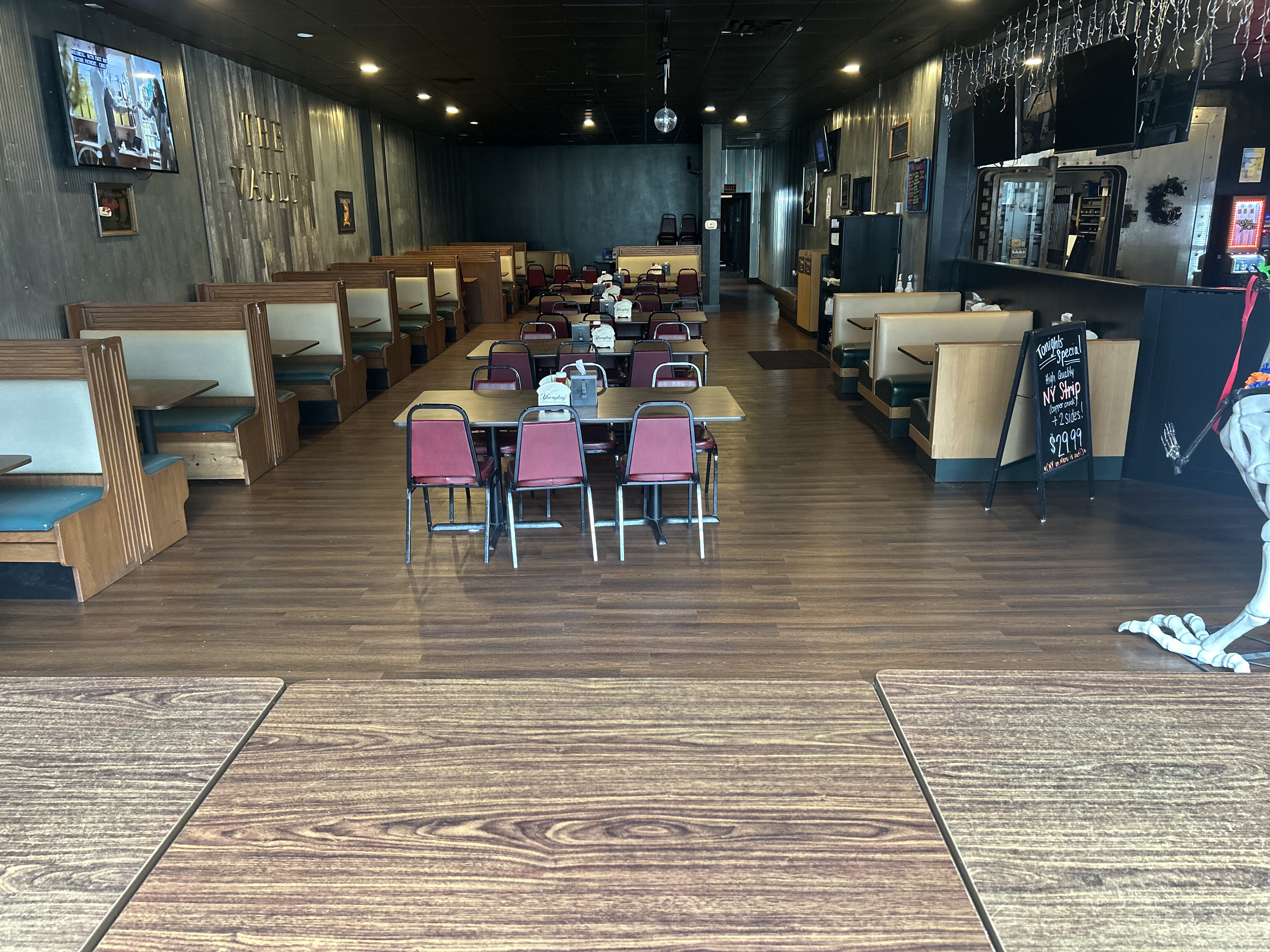The Vault dining room — booths, tables, and the marker board visible in the background